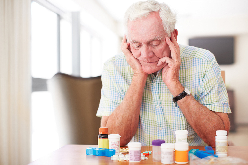 Photo of an older person looking at their medication